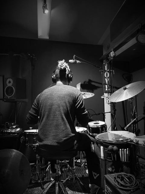 Toby at the drum kit in the studio